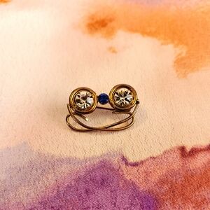 Vintage 1960s tiny brass eyeglasses pin with blue & clear rhinestones